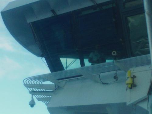 Captain in Crows nest watching Pilot boat arriving